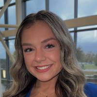 Female student professional headshot in front of windows